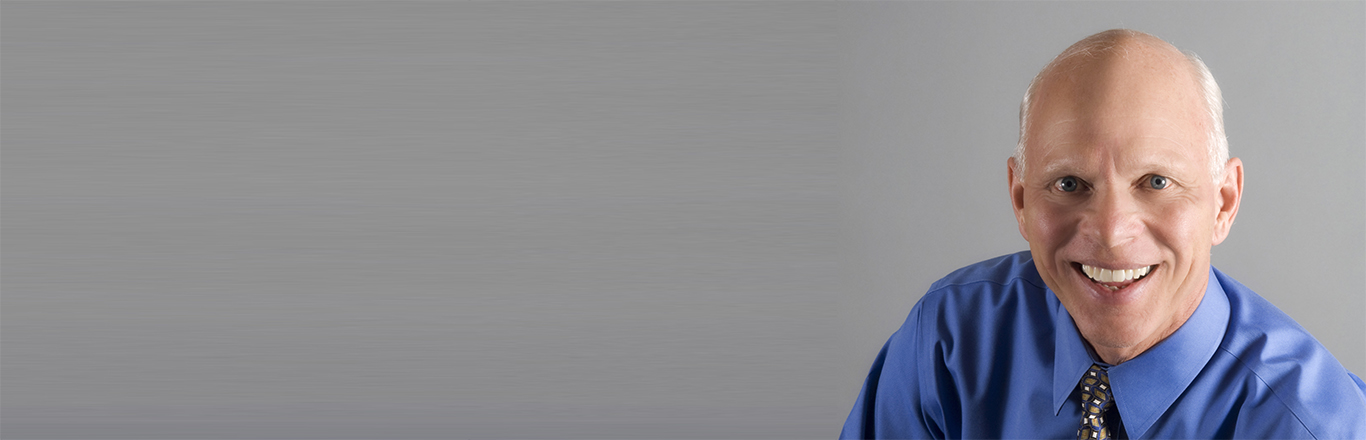 Dr. Merlin Switzer looking at the camera in a blue shirt and tie